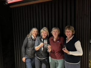 The four ladies in the golf team pictured with their trophy